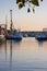 Ships with reflection in harbour at sunrise