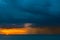 Ships in the sea on a background of clouds with rain during sunset / sunrise