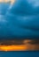 Ships in the sea on a background of clouds with rain during sunset / sunrise