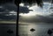 Ships at sea, clouds, setting sun and palm trees