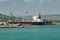 Ships, vessels, boats, containers, industrial buildings at the Puerto Plata harbor, port and cityscape, Dominican Republic