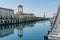 Ships, yachts and boats on blue surface of Black Sea by pier of Commercial seaport of Sochi.