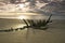 Shipwreck on a beach at sunset