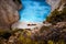 Shipwreck in Navagio beach. Azure turquoise sea water surrounded by huge rocks. Famous tourist visiting landmark on