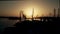 Shipyard cranes and the sea harbour in the evening