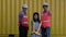 In a shipyard, a happy father daughter and senior engineers celebrate, and a happy family visits a shipping container site