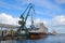 Shipyards and docks with cranes and other heavy machinery near in industrial part of old town Gdansk, Baltic coast, Gdansk bay, Po