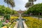 Shiraz, Iran - 04.14.2019: People walking in Eram persian garden of Shiraz on a beautiful sunny day.