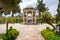 Shiraz, Iran - 04.14.2019: People walking in persian garden with a stone gazebo. Tomb of Hafez Shirazi, famous persian