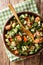 Shirazi salad of fresh vegetables and herbs close-up on a plate. Vertical top view