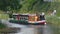 Shire Horse pulls a barge on The Grand Western Canal Tiverton In Devon