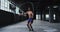 Shirtless african american man skipping the rope in an empty urban building