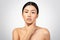 Shirtless Asian Lady Delicately Touching Her Neck Over Gray Background