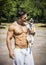 Shirtless Athletic Man with Dog in his Arms