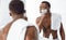 Shirtless Black Guy Shaving Face In Morning Standing In Bathroom