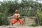 shirtless buddhist in harem pants meditating