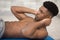 shirtless fitness instructor performs abs