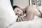 Shirtless hunky man with beard lies naked in bed