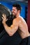 Shirtless male athlete lifting tire