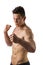 Shirtless male model throwing punch towards camera