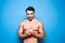 Shirtless man with beard on blue background