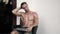 Shirtless man with muscular body sits in chair outdoor and opens laptop for work