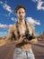 Shirtless man with professional photo camera in desert