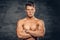 Shirtless muscular male on grey background.