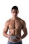 Shirtless muscular young man solving crosswords puzzles