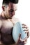 Shirtless rugby player holding ball