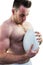 Shirtless rugby player holding ball