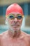 Shirtless senior swimmer wearing goggles