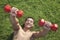 Shirtless, smiling, muscular man exercising with dumbbells in Grass, view from above