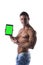 Shirtless young male bodybuiler holding ebook reader or tablet PC