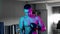 Shirtless young man boxer putting boxer gloves in blue and purple neon lighting