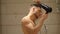 Shirtless young man drying hair with hairdryer