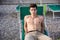 Shirtless Young Man Sunbathing in Lounge Chair on Beach