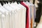 Shirts hanging on rack in shop at community marketplace for men clothing