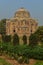 A shish gumbad monument at lodi garden or lodhi gardens in a city park from the side of the lawn at winter foggy morning