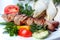 Shish pork kebab with greens and vegetables