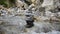Shiva Linga crafted from pebbles and rocks, placed in a river stream at Kinner Kailash Yatra in Himachal Pradesh, a Hindu