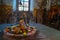 Shiva Lingam temple interior ornate with flowers and colors with majestic light coming from window, India. Architectural details o