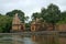 Shiva temple and bell tower on the bank of river krishna in rainy season