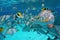 Shoal of tropical fish underwater close to surface