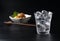 Shochu and nibbles set against a black wood grain background