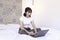 Shock asian beautiful girl work the laptop in the bed. Work from home concept