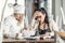 Shock over bookkeeping by female chef and restaurant owner, sitting over paperwork