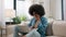 Shocked African American woman negative bad emotion sad upset worried anxious confused reaction laptop notification bank