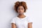 Shocked Afro American woman gazes surprised isolated over white background with blank empty space