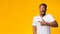 Shocked Afro Guy Pointing Finger Aside Standing, Yellow Background, Panorama